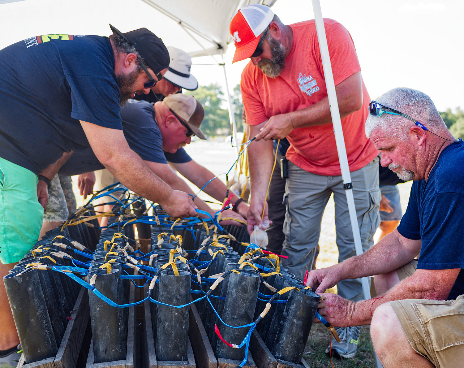 Members of the Mineola Fire Dept. prepare the fireworks for Monday night's show.